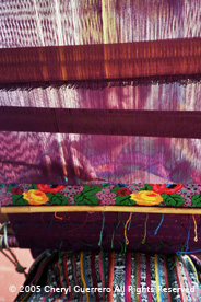 Back strap weaver Esperanza Lopes weaves in her home in San Antonio Aguas Calientes. The shoulder portion of the huipil is double faced supplementary weft brocade.  Photo by Cheryl Guerrero 2005.