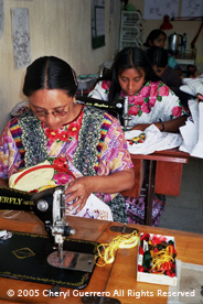Some workshops do both machine and hand embroidery, as in the workshop Guipil de Nebaj in San Juan Ostuncalco.  Photo by Cheryl Guerrero 2005.