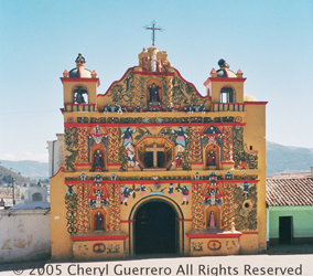 The Church of San Andrés Xecul boasts a mustard yellow façade with delightfully painted figures.  Photo by Cheryl Guerrero 2005.