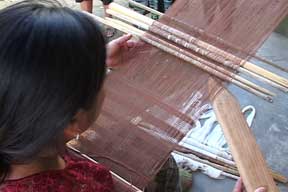 In Baleu, an agricultural area about 40 minutes west of San Cristóbal Verapaz, Josefina Xoná Gualím weaves a calada or open weave panel on a back strap loom. Photo by Kathleen Mossman Vitale 2005.
