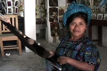 Catalina Lopez Sajvin weaves a huipil panel on a back strap loom at her father's store, Galería Ordoñez, in Santa Catarina Palopó.  Photo by Paul G.Vitale 2004.