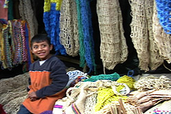 This boy's family owns a stall in the Chichicastenango market that sells both maguey (agave) and plastic bags and ropes.  Maguey items tend to last longer, but plastic is cheaper.  Photo by Kathleen Mossman Vitale 2005.