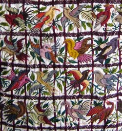 Birds are a favorite subject of embroiderers in Santiago Atitlán. Embroidered birds decorate women's blouses and men's pants, as well as panels sold to tourists. Photo by Denise Gallinetti 2005.
