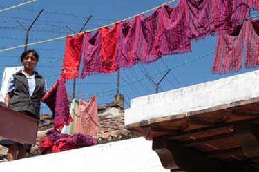 Hand loomed textiles brought in from highland communities are washed, dried, ironed and sorted for quality at Culibrí in Antigua.  Owner Vey Smithers has worked for decades with indigenous communities to develop marketable products while maintaining their style of weaving.  Photo by Denise Gallinetti 2005.