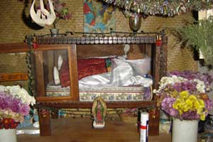 María Castellana, the wife of the Maya saint Maximón, is dressed in finely woven textiles and an embroidered belt, and displayed in a private home setting. Photo by Denise Gallinetti 2005.