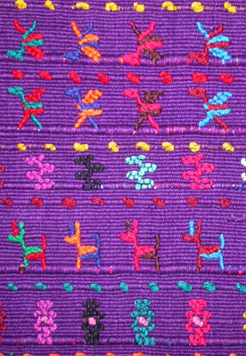This textile sample was woven on a back strap loom in the style of San Lucas Tolimán, with rows of dogs, birds and stars formed from supplementary weft brocading.   Photo by Kathleen Mossman Vitale 2005.