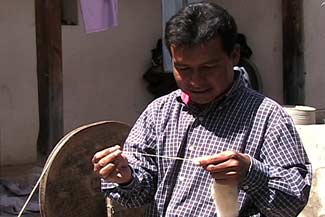 Jesus Ajanel Vicente still remembers the skills he learned as a child in Momostenango, such as spinning wool.  Photo by Kathleen Mossman Vitale 2005.