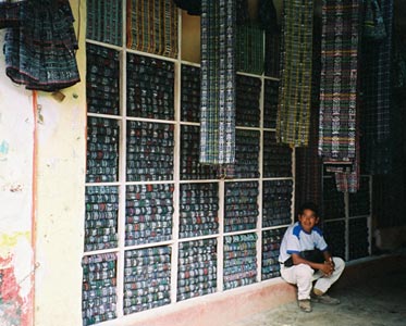 Most Maya women in Guatemala wear cortes or skirts of jaspe or ikat fabric. The textile is made from thread that is bundled, tied and dyed prior to weaving. Sololá and Totonicapán are centers for jaspe production. Vendors throughout the highlands sell a plethora of jaspe textiles.  Photo by Margot Blum Schevill 2005.