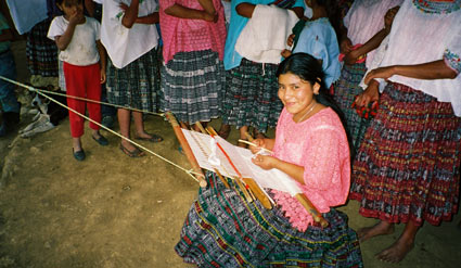 María Elena Xol Ae also weaves in the pikb'il style.  The huipil or blouse she wears, however, is machine made and purchased in a market.  Her corte or skirt is jaspe or ikat, where the threads are tied and dyed prior to weaving.  Photo by Margot Blum Schevill 2005.