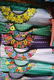 Markets throughout Guatemala now offer huipiles or blouses of machine-made fabric and machine embroidery.  Photo by Margot Blum Schevill 2005.
