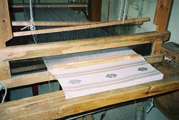 This large loom in the headquarters of Nu'Kem Association of Weavers in Tactic is used to produce table runners, placemats and large tablecloths for the tourist market.  Photo by Margot Blum Schevill 2005.