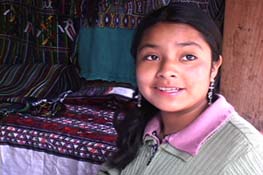 Helena Estella Covo Santiago, 14, works fulltime weaving and running a textile stall in Nebaj to help support her siblings. Photo by Cheryl Guerrero 2005.