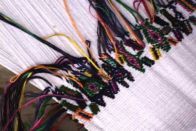 A row of colorful horses in supplementary weft brocade is almost complete in this back strap weaving by Helena Estella Covo Santiago, Nebaj.  Photo by Kathleen Mossman Vitale 2005.