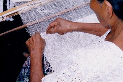Rosalía Xol Xol, a widow from the 36-year civil war, weaves an ancient style called Pikb'il.   The woven designs of ducks and stars are made by supplementary weft brocading. Photo by Jonathan Tharin 2005.