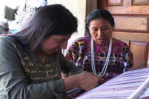 Francisca Maldonado instructs Peace Corps Volunteer Tina Gallegos in weaving her first huipil panel using local designs.  Photo by Kathleen Mossman Vitale 2005.