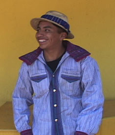In Todos Santos Cuchumatán, Santiaga Mendoza Pabla's son William, 17, enjoys a ribbing from friends.  He wears the typical palm fiber hat and woven shirt still prevalent in his community. Photo by Kathleen Mossman Vitale 2005.